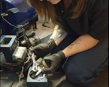 Find a technician Female heating technician servicing oil boiler