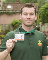 OFTEC registered heating technician showing ID badge